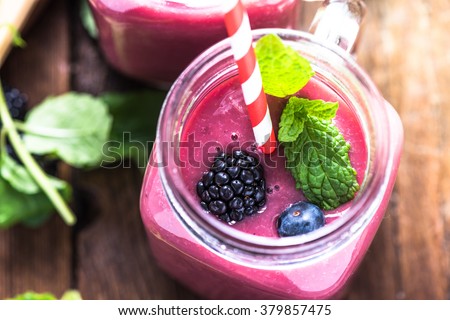 Well being and weight loss concept, berry smoothie.On wooden table with ingredients, from above. Royalty-Free Stock Photo #379857475