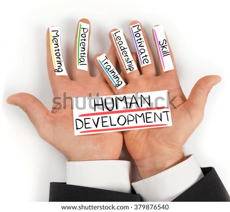 Photo of hands holding paper cards with HUMAN DEVELOPMENT concept words