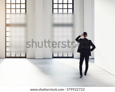 Businessman thinking and advertising bubble, in loft modern office interior