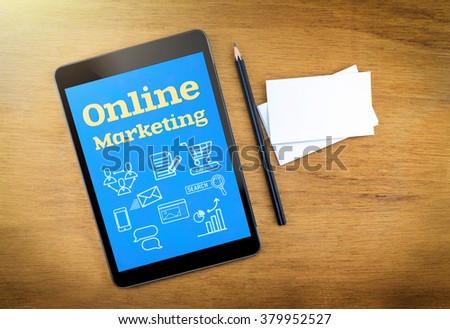 Online Marketing on mobile device screen with pen and business card on wood table,Digital marketing concept