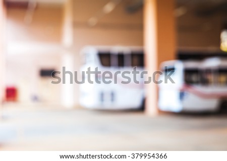 blur image of buses parking on building 