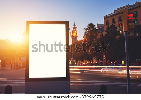 Illuminated billboard with blank copy space screen for your advertising text message or promotional content, empty Light-box for information with night city on background, clear poster in urban scene