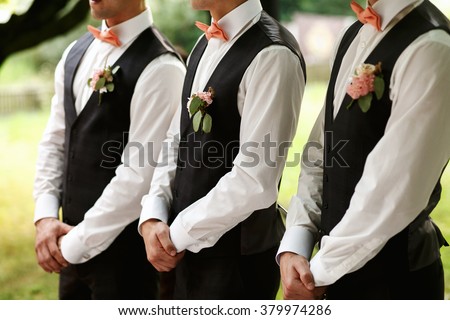 Groomsmen standing on the wedding ceremony outdoors Royalty-Free Stock Photo #379974286