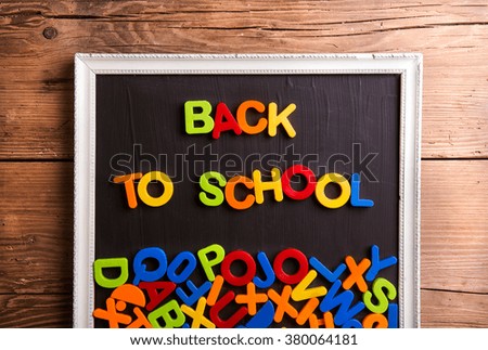 Colorful plastic letters in picture frame, back to school,