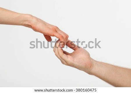 Man's hand gently holding woman's hand - closeup shot