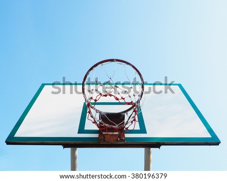 look up to basketball hoop cage over clear blue sky background