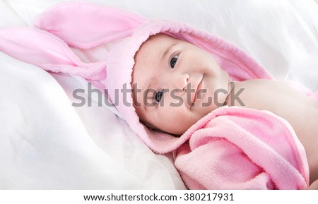 Baby in bunny costume on a white background