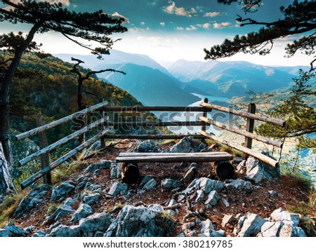 The observation deck in Serbia. Stunning views from a cliff into the river Drina through the pines. Bosnia and Herzegovina on the opposite side of the river. Royalty-Free Stock Photo #380219785