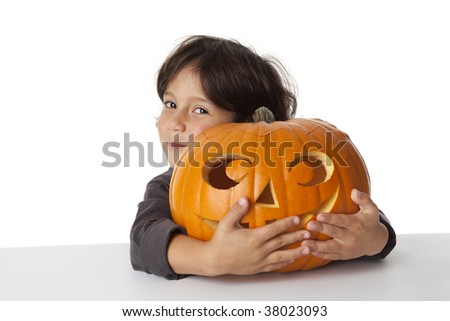 Little boy with a Halloween pumpkin at white background