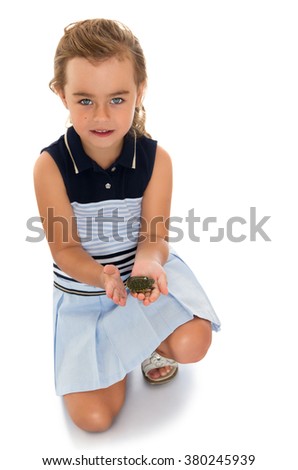 Amazing view of a little girl who is holding a small turtle - Isolated on white background