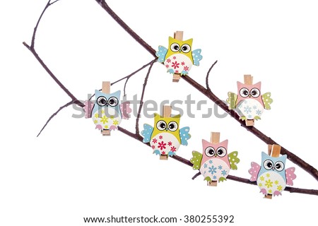 Wooden owl pegs on a twigs