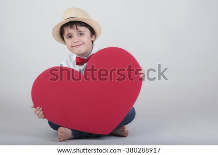 smiling boy with a red heart
