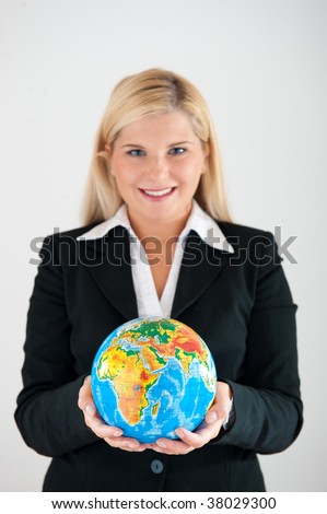 Picture of a young friendly beautiful female office worker in a suit holding a globe