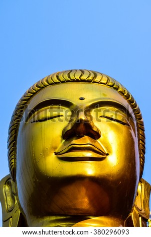 Buddha portrait on blue sky.