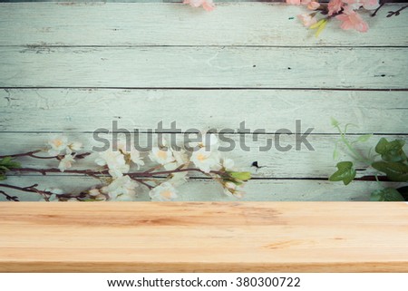 Wood table top on wood and flower background- can be used for display or montage your products