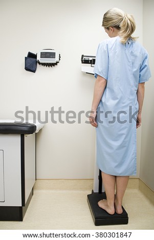Woman on scales in examination room
