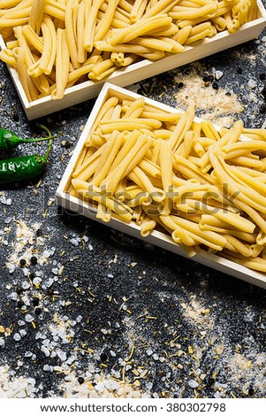 raw pasta in a box on a dark background