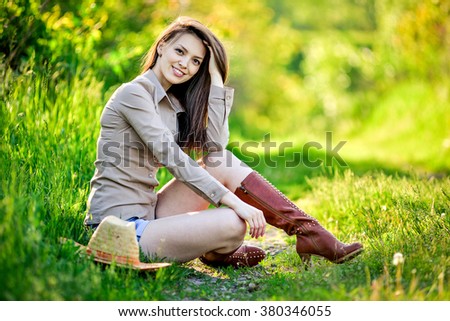 young beautiful girl in a cowboy hat, country style