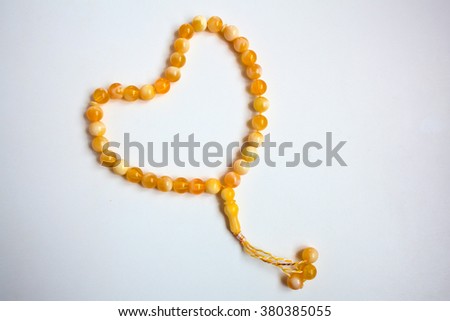 Koran and wooden bowl and beads Royalty-Free Stock Photo #380385055