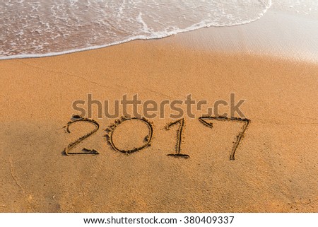 New Year 2017 is coming concept - write  2017 on a beach sand