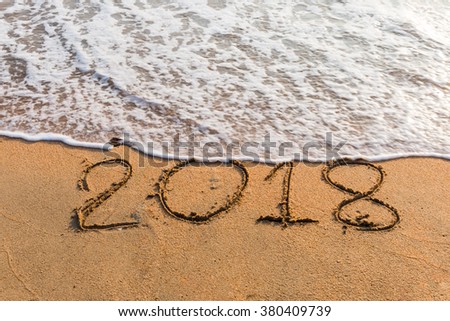 New Year 2018 is coming concept - write  2018 on a beach sand