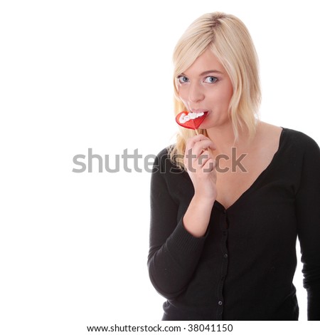 Teenage girl holding red heart shaped lollipop isolated