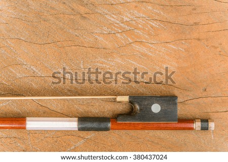 Violin Bow, fiddle stick on wooden background - close up 
