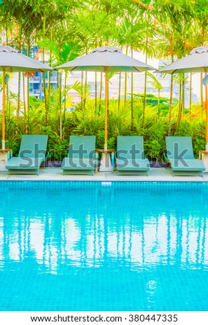 Beautiful luxury swimming pool with umbrella and chair in luxury hotel resort - Boost up color Processing style