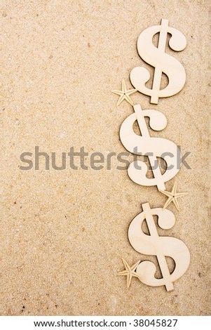 A gold coloured dollar symbol sitting on a beach with starfish, vacation money