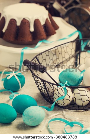 Decoration of Easter cake and eggs in blue tones. Vintage style. Image toned.
