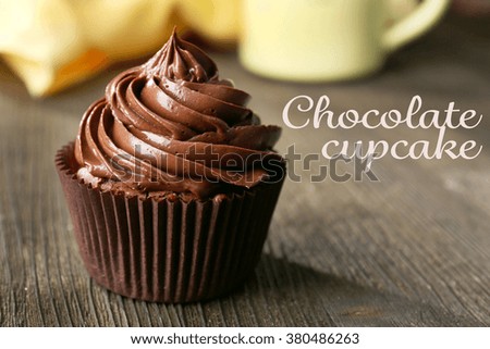 Chocolate cupcakes served with a drink on wooden table