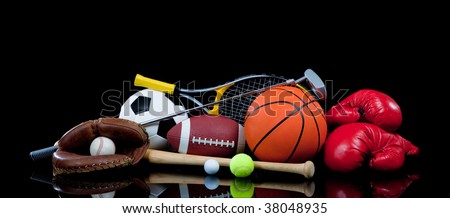 A group of sports equipment on black background including tennis, basketball, baseball, american fotball and soccer and boxing equipment on a black background with copy space Royalty-Free Stock Photo #38048935