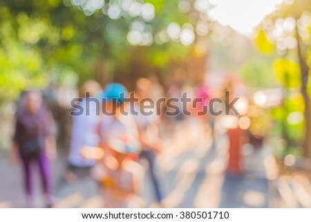 blur image of people walking in the park  with bokeh for background usage .