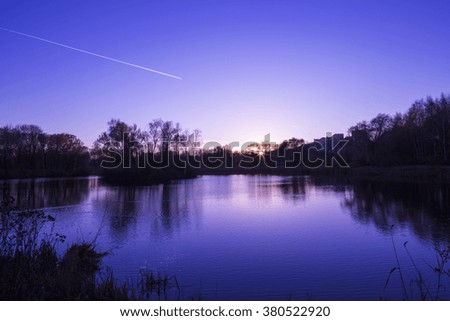 Beautiful sunset over the lake. Sunset sky in autumn in Russia, the landscape. 
