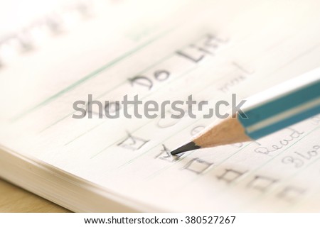 close up Handwritten to do list plan in a  small note book ,  extremely shallow DOF Royalty-Free Stock Photo #380527267