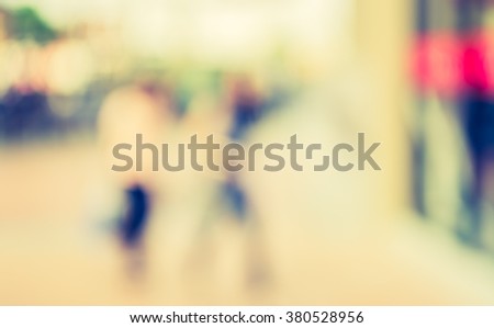 Abstract blur background image of people shopping and walking in shopping street with vintage tone look.
