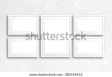 Five blank photo frames set on modern textured background