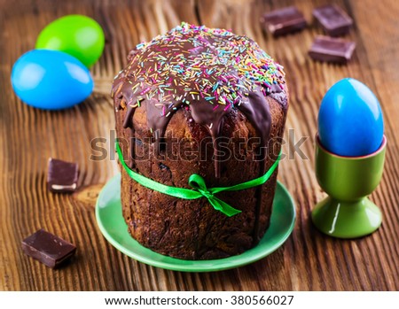 chocolate Easter cake with glaze on a wooden background