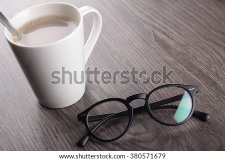 few nescafe sachets with a fresh hot nescafe mug on wood background