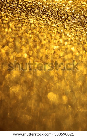 Adorable yellow golden sparkling glittery pane glass glisten natural background bright shiny decorative relief texture copyspace, vertical picture