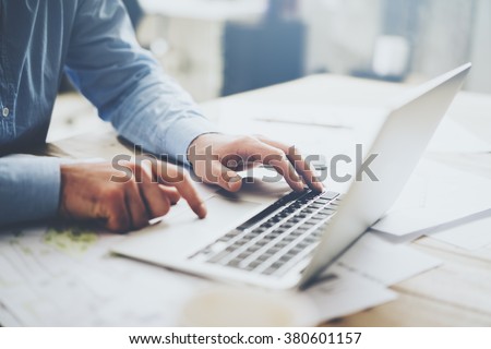 Businessman working laptop for new architectural project. Generic design notebook on the table. Blurred background, horizontal mockup. Royalty-Free Stock Photo #380601157