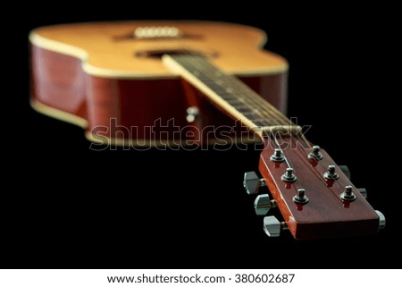 Beautiful acoustic guitar isolated on black background
