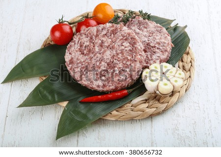 Raw beef merle burger cutlet on the bamboo leaves
