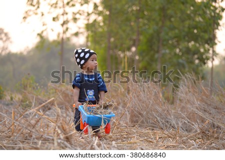 asian girl playing in cornfield