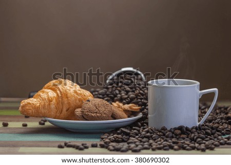 Cookies and coffee cup with beans background