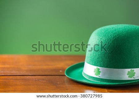 lucky green hat for st. patricks day on rustic wood background