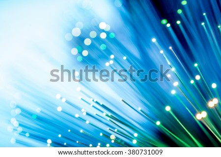 Glowing Fiber Optic Channels Closeup Photo. Fiber Channel Background. Royalty-Free Stock Photo #380731009