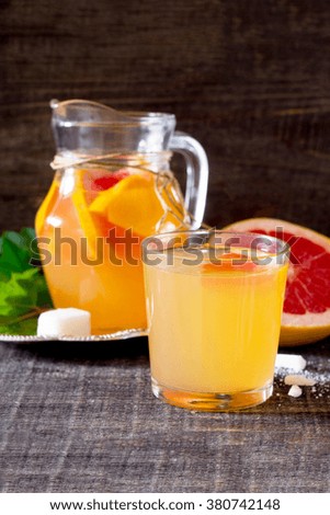 The drink of fresh grapefruit on a dark wooden table
