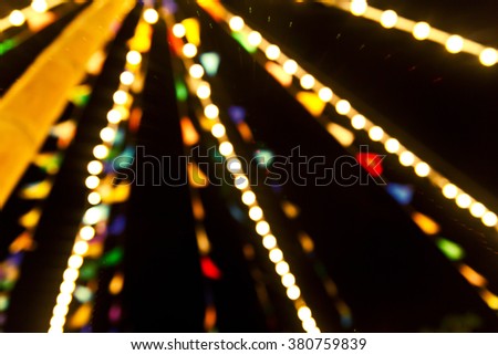 Blurred night market background : Decoration with Marking Flag Strips Festival  Vintage lights background.