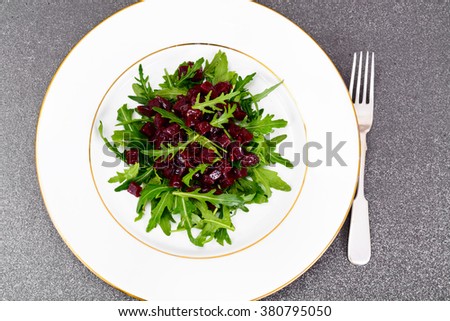 Dietary food without meat: Salad with arugula and beet. Studio Photo